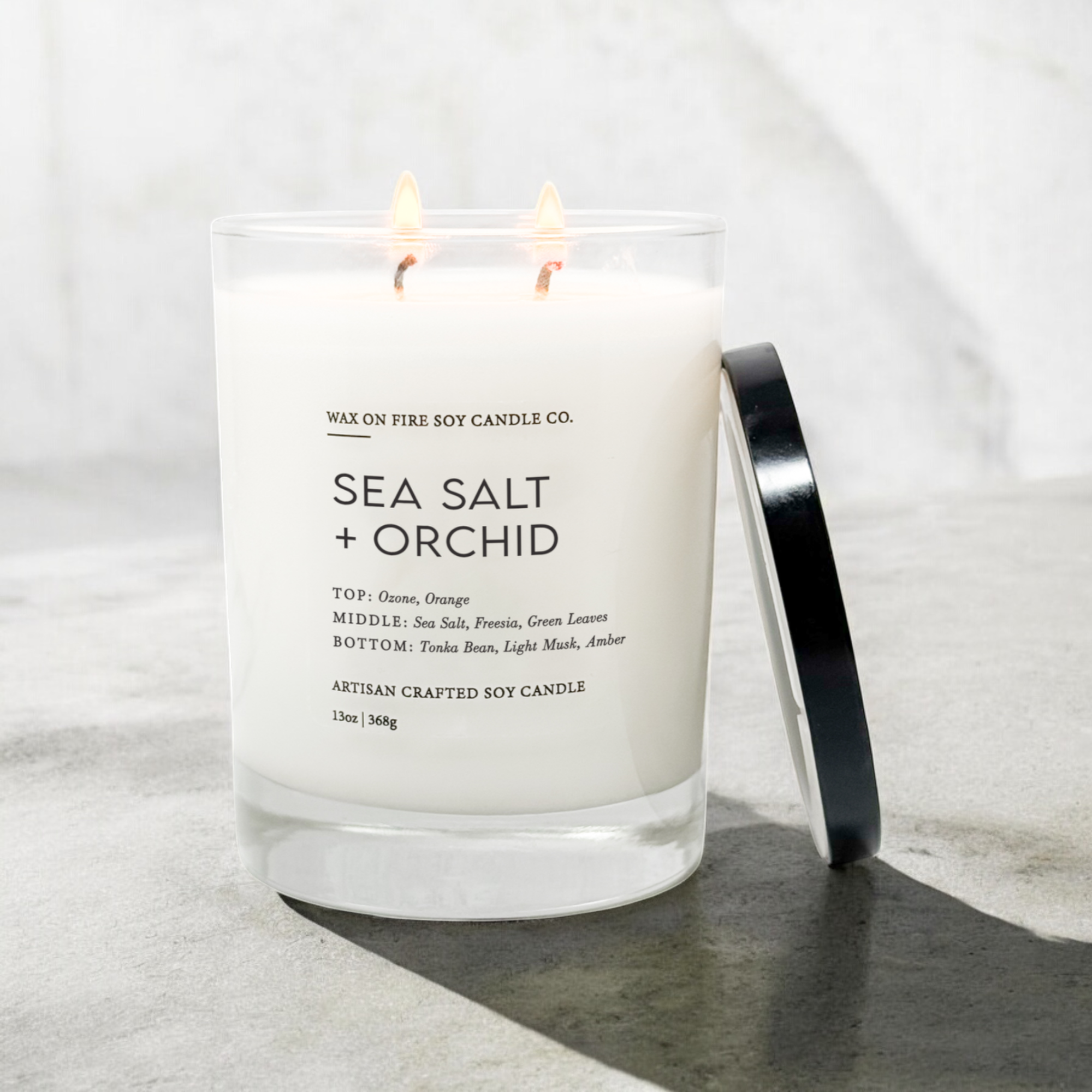 a sea salt and orchid candle sitting on a table