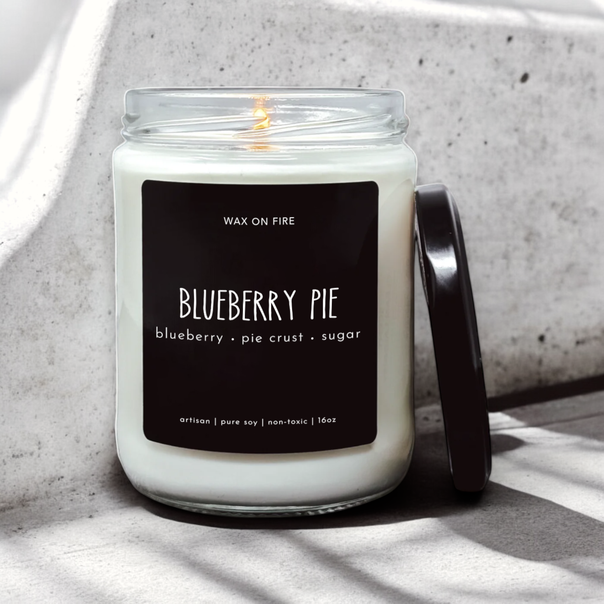 a blueberry pie candle sitting next to a wall