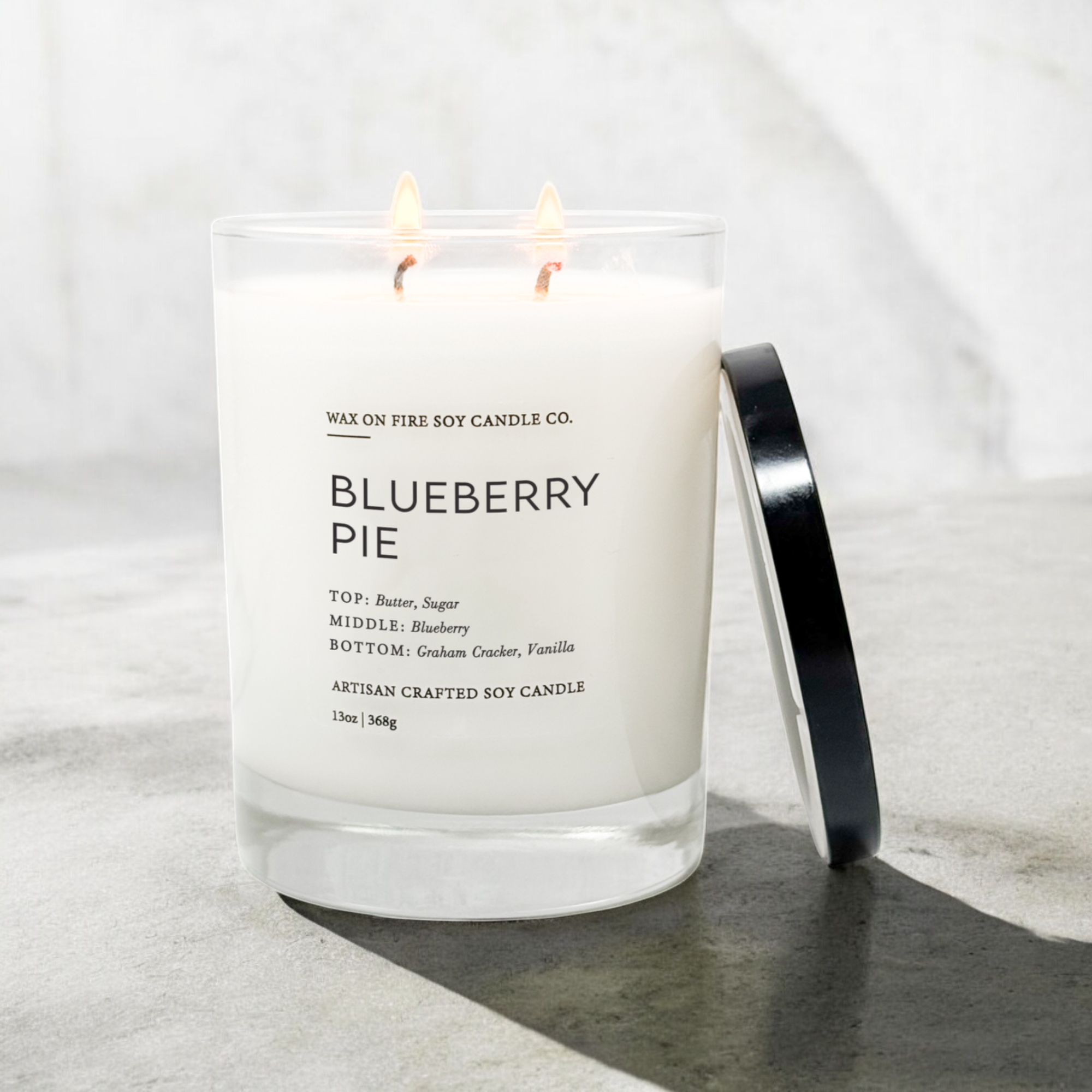 a blueberry pie candle sitting on a table